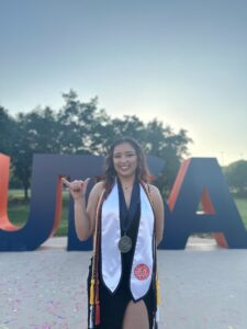 Portrait of a graduate wearing a gown and stole